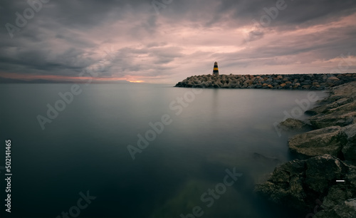 Cloudy sunrise scenery of Lighthouse at Banalmadena coast in Malaga, Spain 
