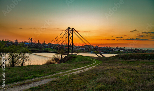 Sunset panorama of railway bridge and industrial city