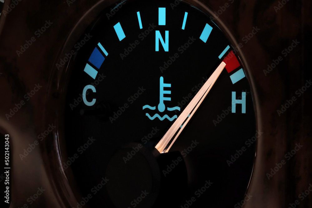 temperature gauge in car dashboard in illuminated night mode hot
