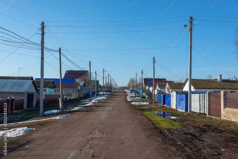 Village with houses and remnants of snow in spring. Village with houses and remnants of snow in spring.