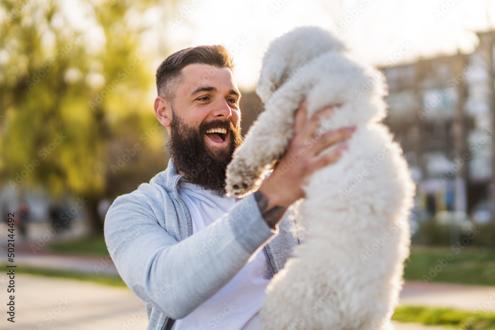 Adult man is enjoying sunny day with his dog. Adult man is enjoying sunny day with his dog.
