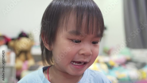Father and son. Boy playing with balloons while laughing in the bedroom.