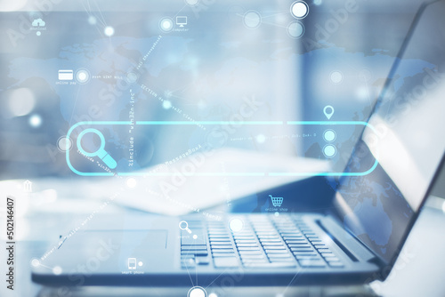 Foto Close up of laptop with creative search bar and digital blue map icons on blurry background