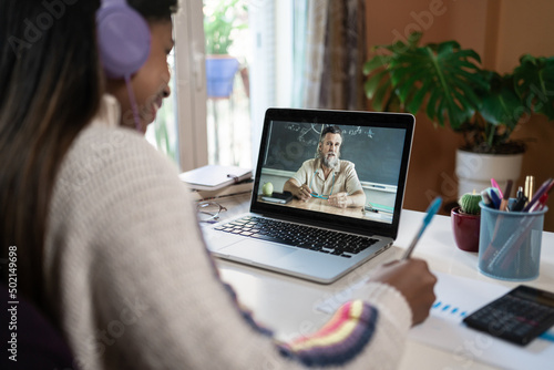 Online Education. Student uses laptop to video call teacher and learn at home