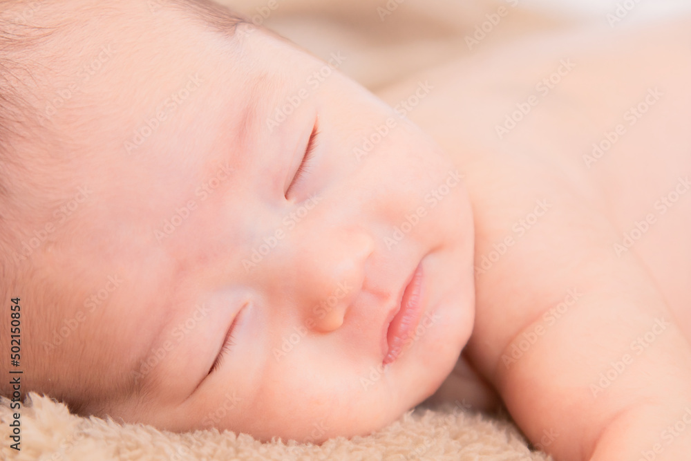 Close up Asian newborn baby sleeping peacefully on beige blanket at home, adorable infant sleep in dream. Little toddler 1-2 month lying on bed with safe. Family morning at home,Children hygiene. Close up Asian newborn baby sleeping peacefully on beige blanket at home, adorable infant sleep in dream. Little toddler 1-2 month lying on bed with safe. Family morning at home,Children hygiene.