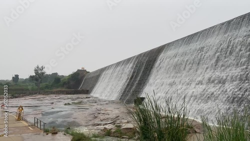 A close-up shot of the water flowing down from a Srinivasa Sagara reservoir dam creates an alluring view. photo