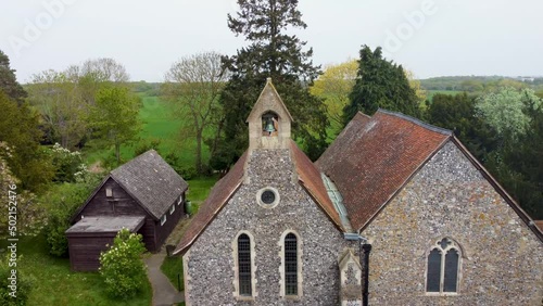 Stunning drone shot of an old village church in England photo