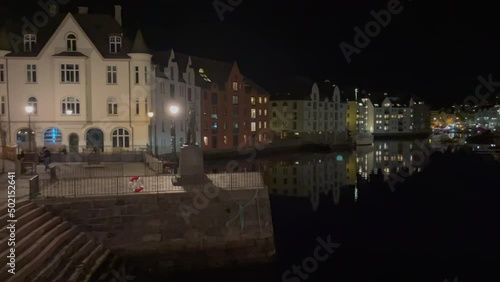 Canal in Alesund at Night near city center, Buildings reflecting on the water surface, Jugendstyle Left to right Shot. photo