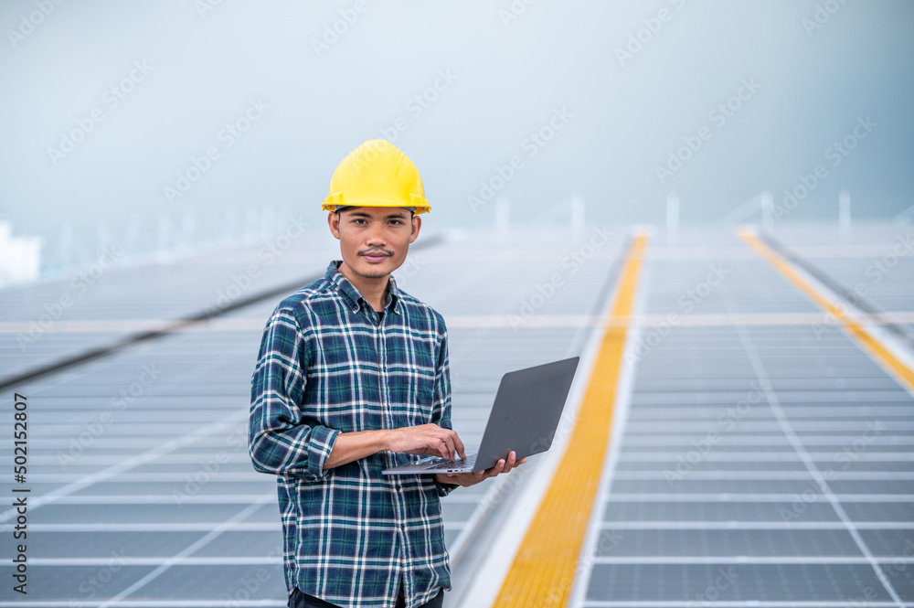 Asia engineer working on roof top soler power plant system renewable energy for future factory or industrial Asia engineer working on roof top soler power plant system renewable energy for future factory or industrial