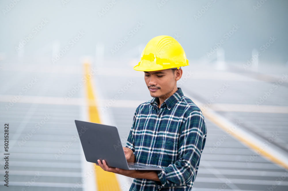 Asia engineer working on roof top soler power plant system renewable energy for future factory or industrial Asia engineer working on roof top soler power plant system renewable energy for future factory or industrial