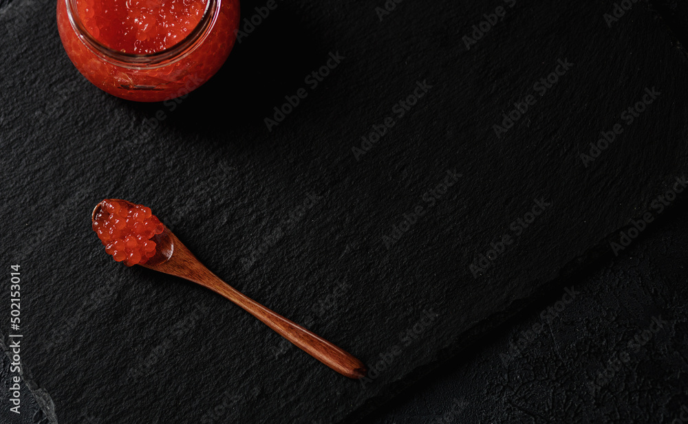 delicious red caviar on dark background delicious red caviar on dark background
