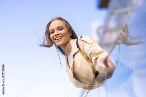 Young woman smile and enjoy standing on balcony in the street