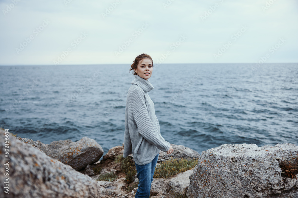 woman freedom walk on the stone coast female relaxing