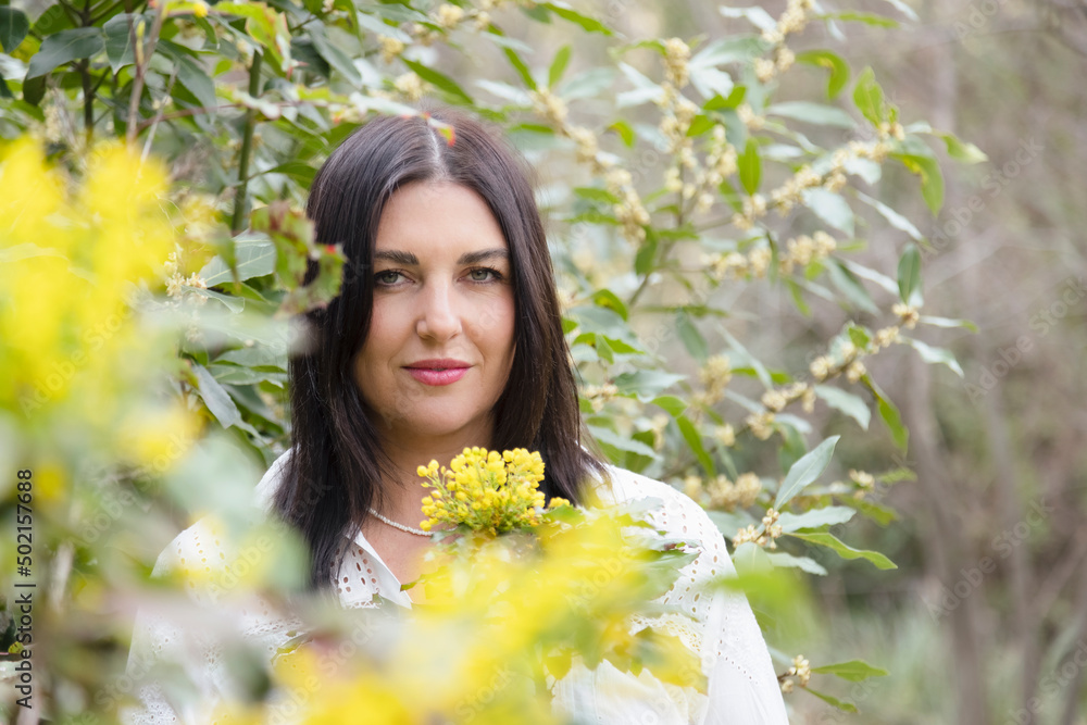 Smiling woman with long hair amidst yellow flowers Smiling woman with long hair amidst yellow flowers