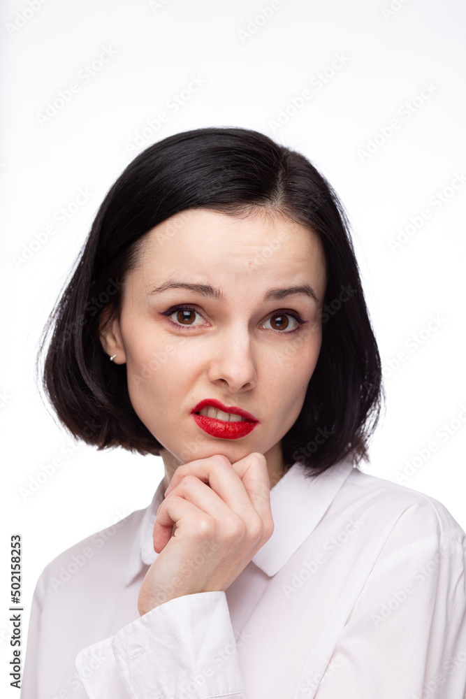 brunette woman with red lipstick on her lips in white shirt, white background brunette woman with red lipstick on her lips in white shirt, white background