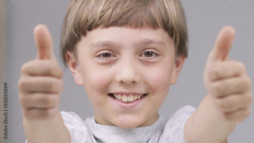 Caucasian boy of 9 years shows smiling the thumbs up Caucasian boy of 9 years shows smiling the thumbs up
