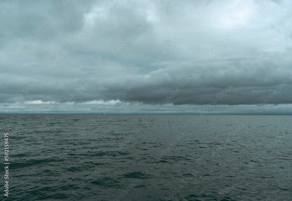 Naklejka premium clouds over the sea