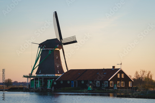 Historical buildings and windmills at dusk in Zaanse Schans, Netherlands