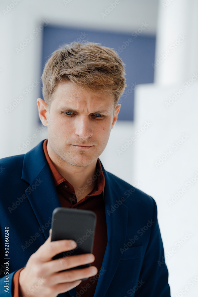 Businessman using mobile phone in office Businessman using mobile phone in office