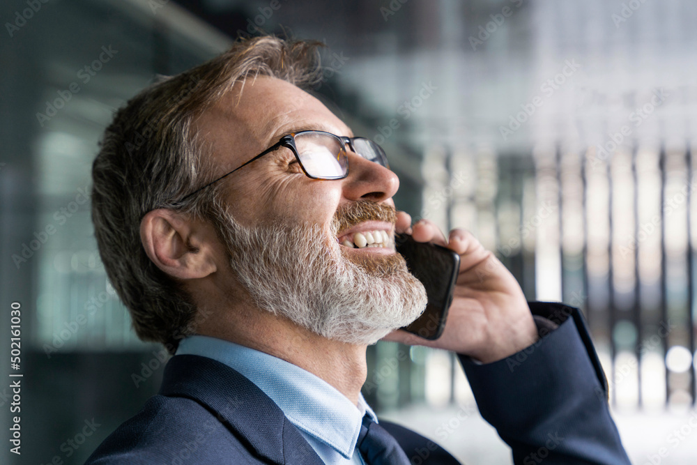 Happy businessman talking on smart phone Happy businessman talking on smart phone
