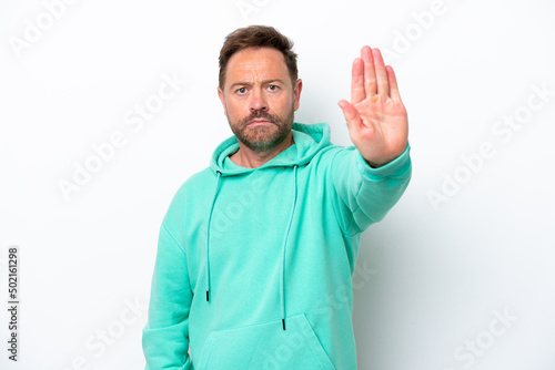 Middle age caucasian man isolated on white background making stop gesture © luismolinero