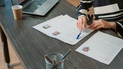 Obraz na plátně Office worker analyzing candidates cv and application form before attending job interview and hiring people