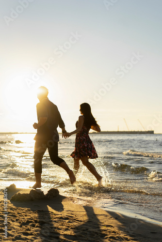 Couple having fun at beach on sunny day photo