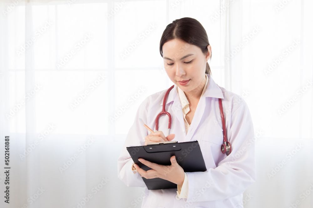 Beautiful asian woman doctor taking note information of patient in paperwork checklist on clipboard in medical room of hospital. Health care, doctor writing prescription paper. Beautiful asian woman doctor taking note information of patient in paperwork checklist on clipboard in medical room of hospital. Health care, doctor writing prescription paper.
