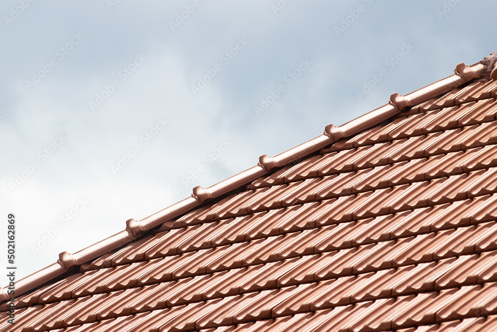 Naklejka premium new red tiles roof and blue sky