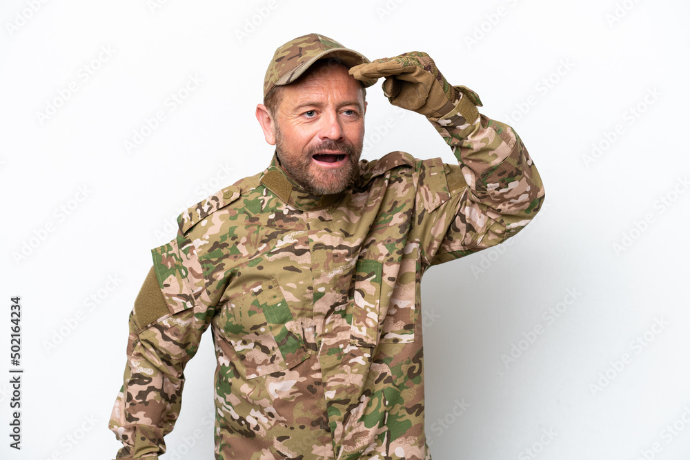 Military man isolated on white background looking far away with hand to look something Military man isolated on white background looking far away with hand to look something