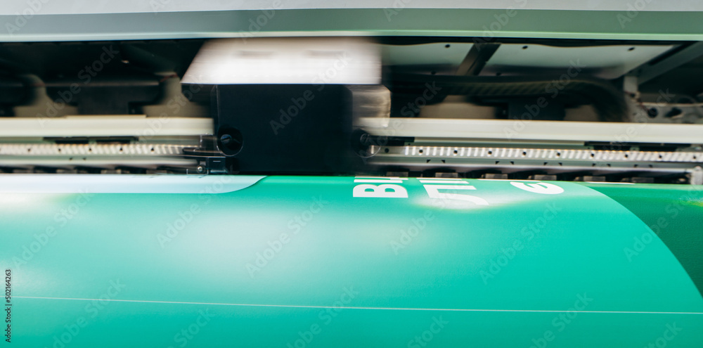 Graphic design and advertising concept. Large format plotter, close up Graphic design and advertising concept. Large format plotter, close up