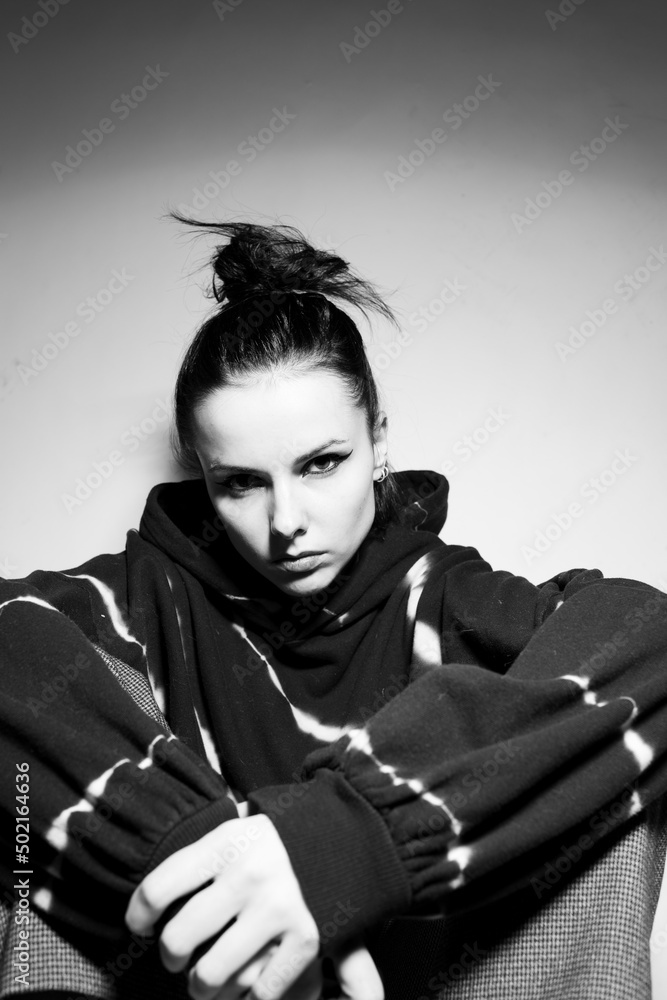 beautiful brunette girl in a black hoodie, light background beautiful brunette girl in a black hoodie, light background