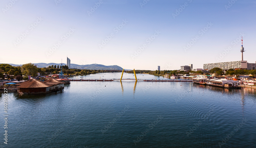 View of the Danube and the pontoon bridge connecting the Leopoldstadt and Donaustadt districts of Vienna at sunset. Austria