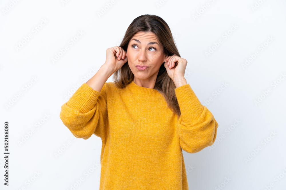 Middle age caucasian woman isolated on white background frustrated and covering ears Middle age caucasian woman isolated on white background frustrated and covering ears