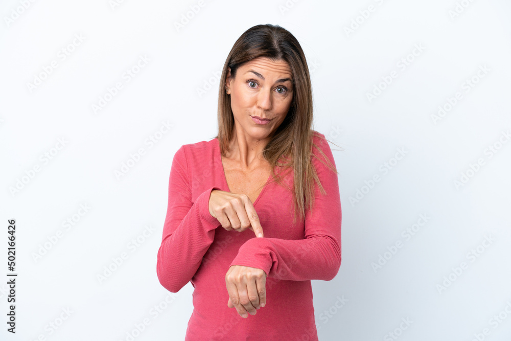 Middle age caucasian woman isolated on white background making the gesture of being late Middle age caucasian woman isolated on white background making the gesture of being late