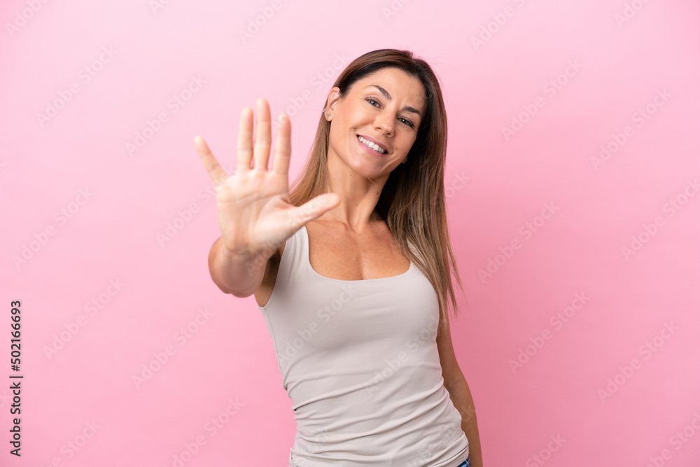 Fototapeta premium Middle age caucasian woman isolated on pink background counting five with fingers