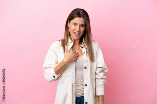 Middle age caucasian woman isolated on pink background pointing to oneself