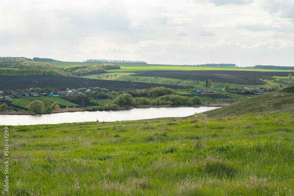 beautiful summer landscape on green hills with a pond beautiful summer landscape on green hills with a pond