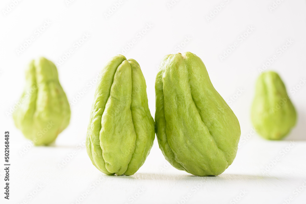 Fresh chayote on white background. Local Asian vegetables are used in vegetarian dishes. Fresh chayote on white background. Local Asian vegetables are used in vegetarian dishes.