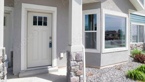 Panorama Townhouse exterior with white front door and bay windows photo