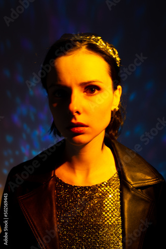 woman with a crown on her head in yellow light, art portrait