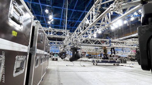Installation of equipment and spotlights for stage. Stock footage. Preparing stage with bleachers and professional equipment and floodlights before performance or competition