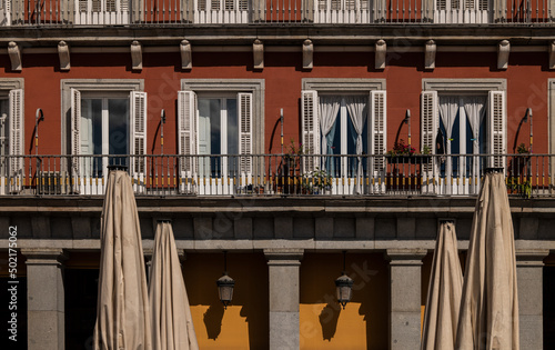 Facade of red building with balconies. Madrid, Spain