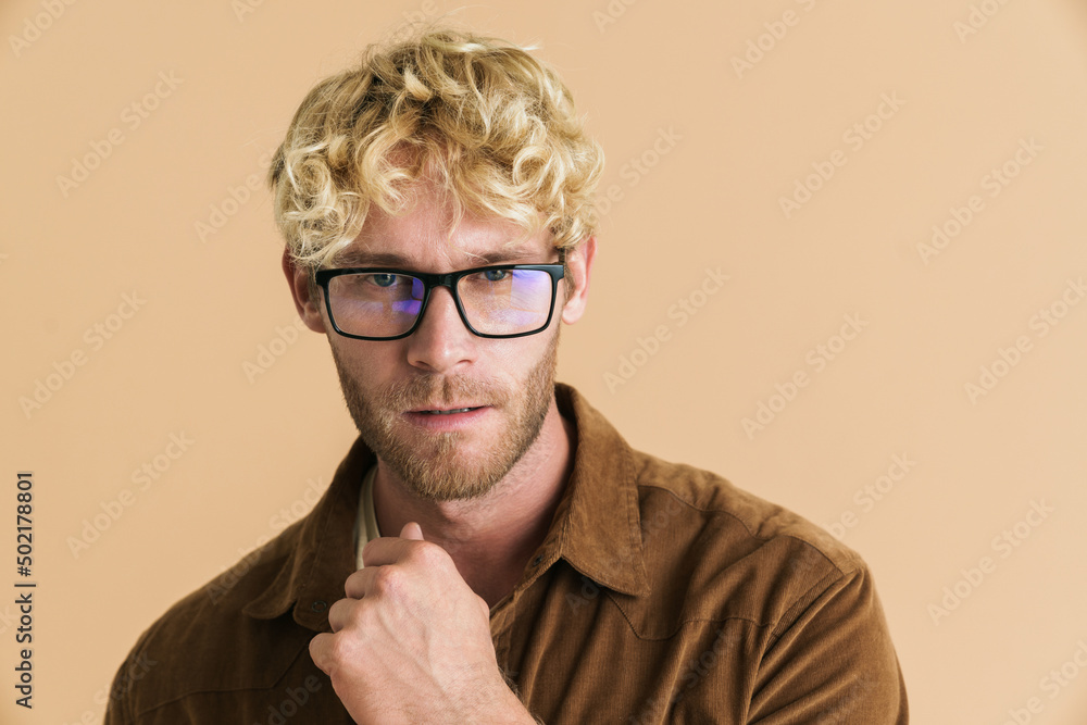 White blonde man in eyeglasses posing and looking at camera White blonde man in eyeglasses posing and looking at camera