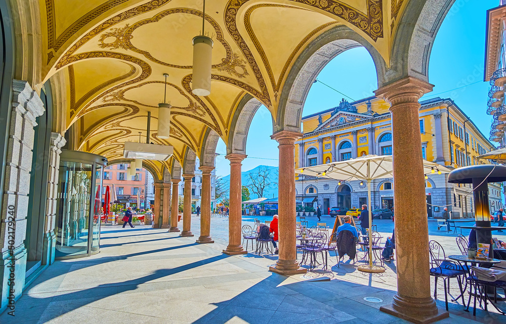 Piazza Riforma and Town Hall through the columns of arcade, Lugano, Switzerland