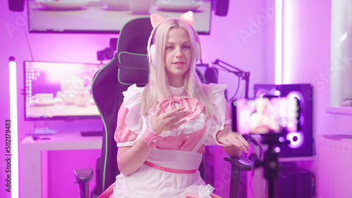 Pink lolita maid influencer gamer girl recording video with smartphone