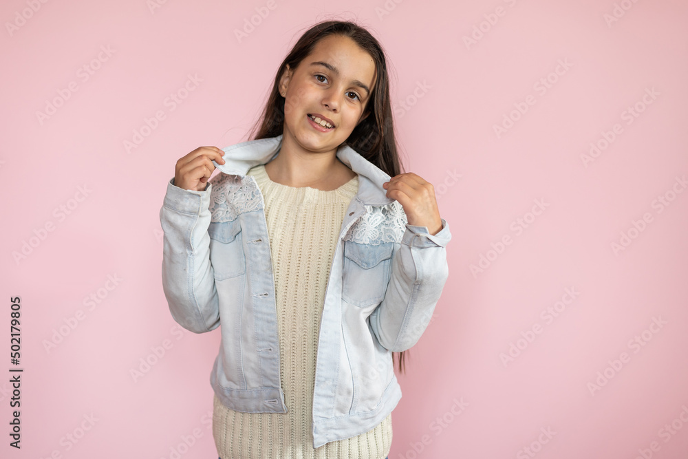 Portrait of pretty kid standing looking wearing trousers isolated over pink background Portrait of pretty kid standing looking wearing trousers isolated over pink background