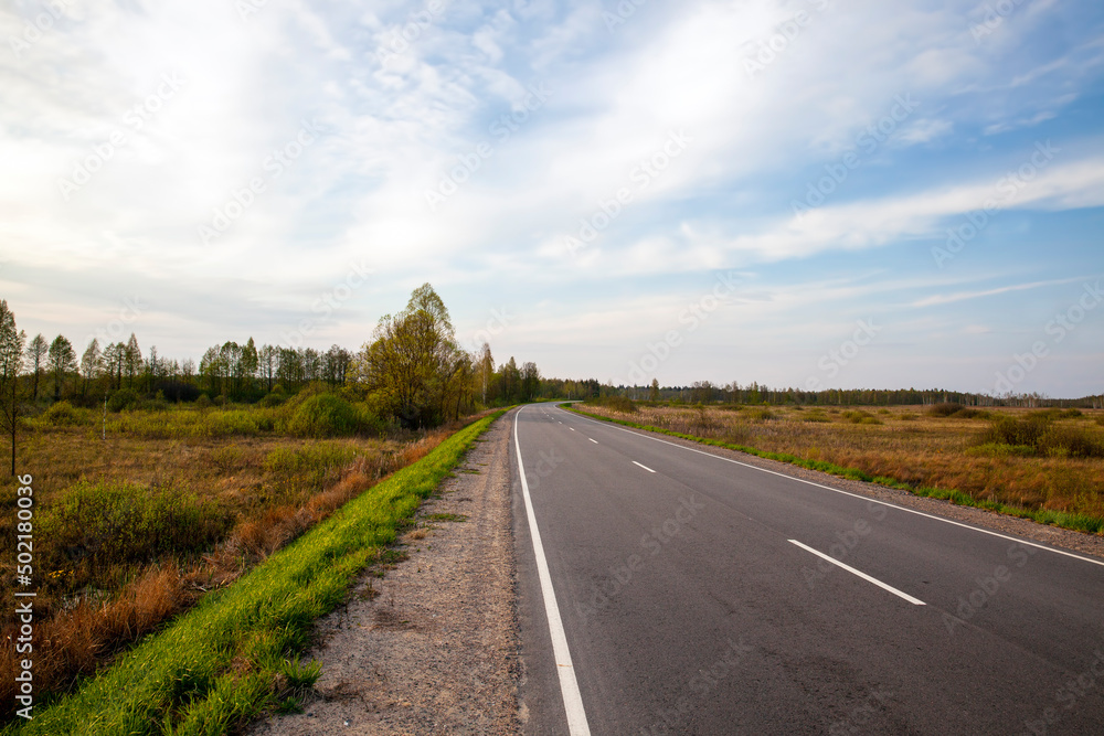 an empty paved road in the countryside