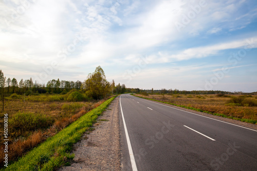 an empty paved road in the countryside