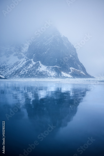 Reflection of a snow copped mountain on a beach during blue hour (ID: 502183222)